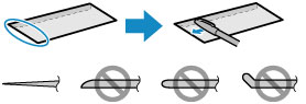 Image showing using a pen to flatten the leading edge of envelopes