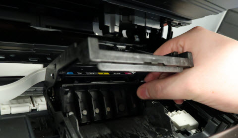 Print head lock lever being pulled out toward the front of the printer