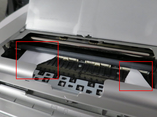 Open the print head cover and remove the piece(s) of paper