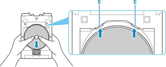 While pressing down the lock with the printable disc, insert the top of the printable disc into the slits (E)