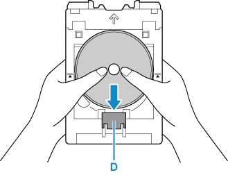 Figure: Place a printable disc and press it against the lock (D) at the bottom
