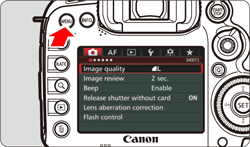 figure showing back of camera and the location MENU button in the upper left