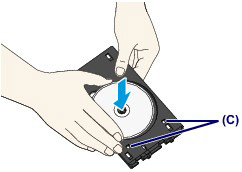 placing a disc into the tray - shown without touching disc surface or reflectors.