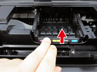 Image: Shows print head seated in the holder and finger pushing the Head Set Lever towards the back of the machine